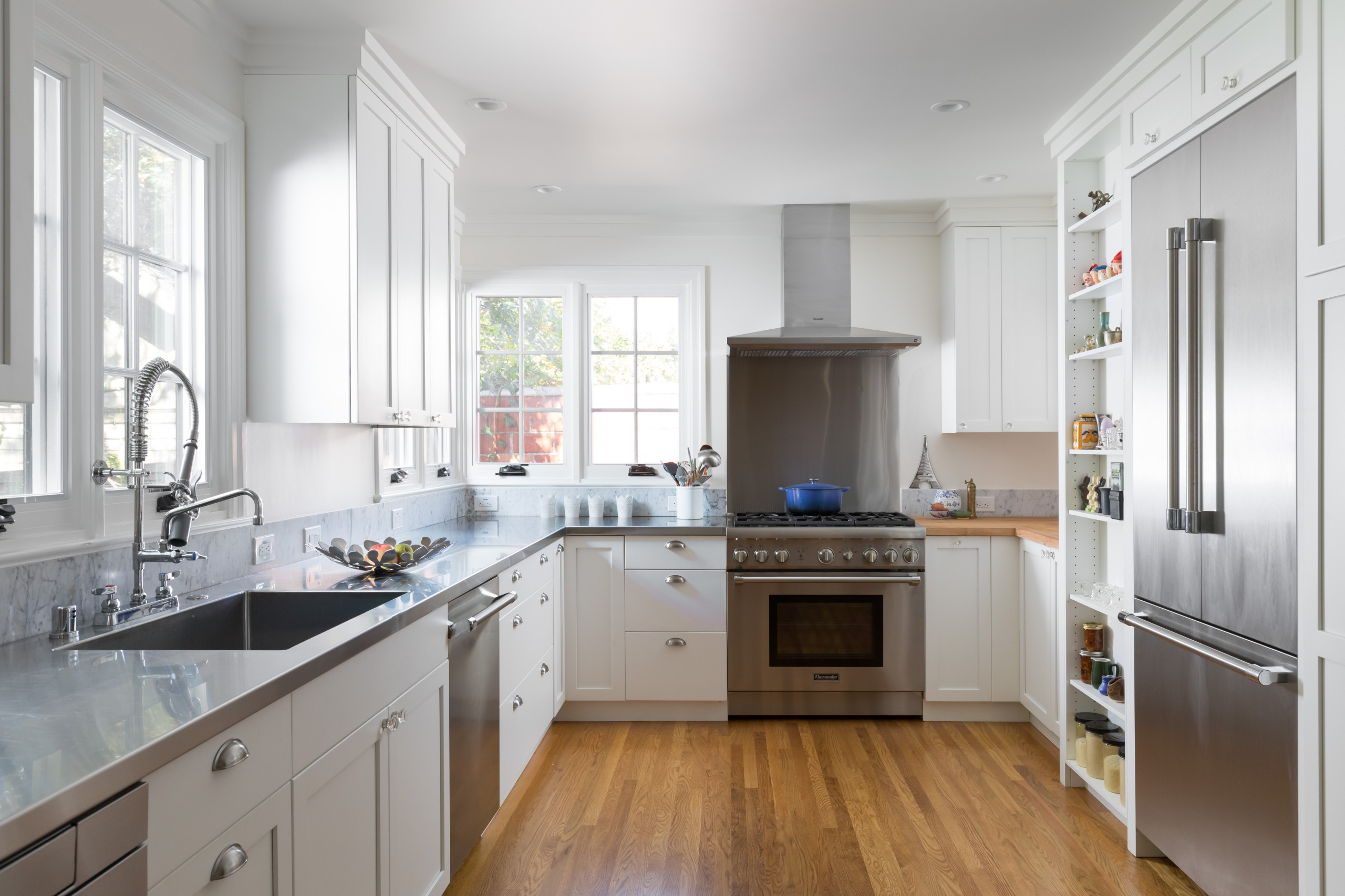 A sparkling clean kitchen with shiny appliances and counters.